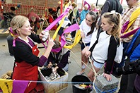 Stove artist Katie Anderson helps some new recruits cast metal spoons with the group's Mobile Metal Foundry at their Trading Journeys project for the Wigtown Book Festival. Image: Colin Hattersley